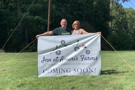 Innkeepers holding coming soon sign