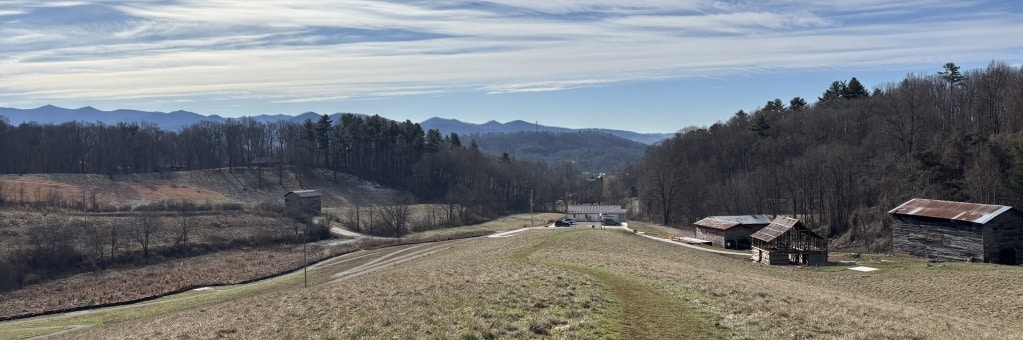 Historic barns and mountain view.