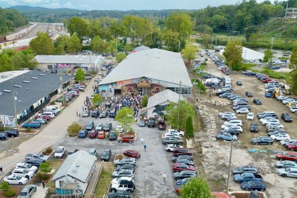 aerial view of a building with cars parked all around