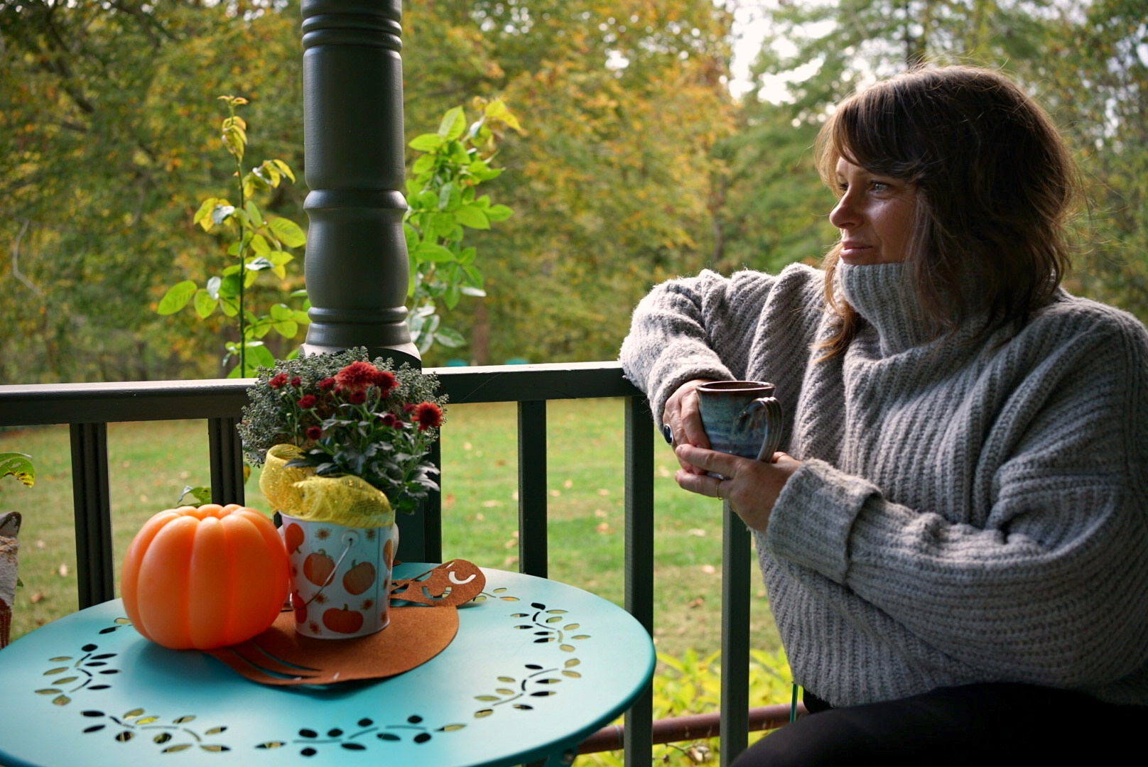 Sitting on a porch with a mug of coffee in the fall