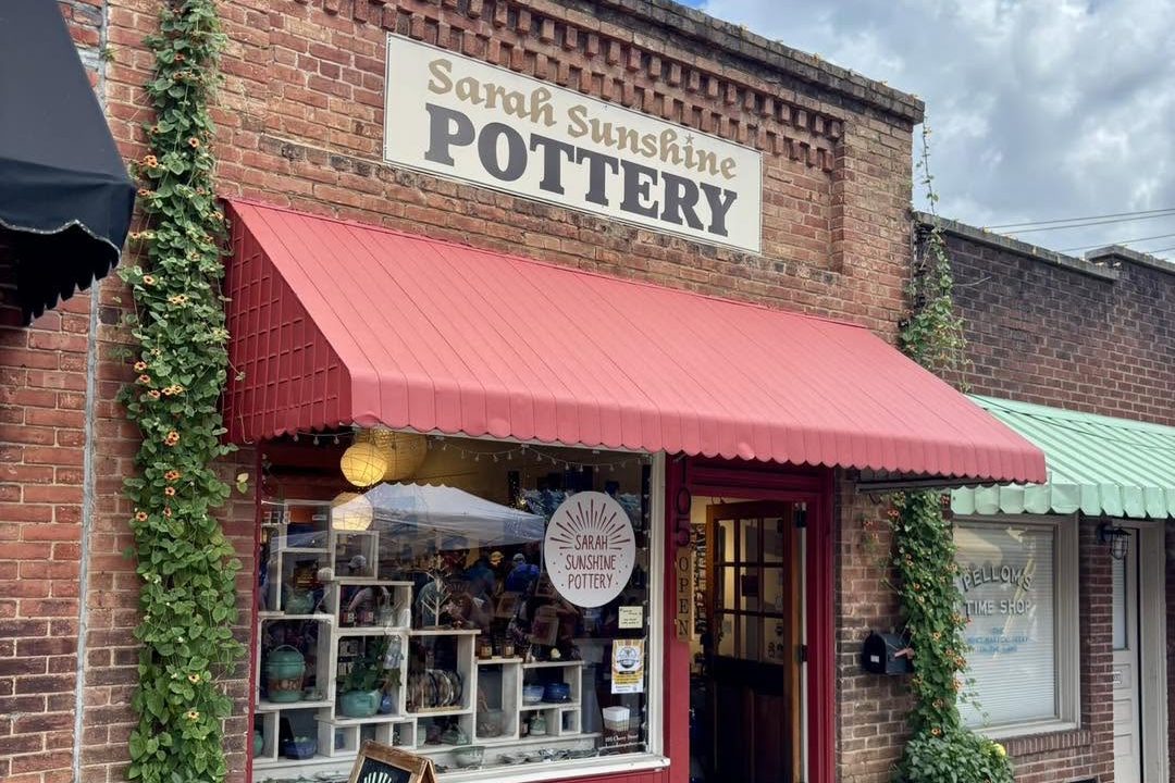 black-mountain-sarah-sunshine-pottery The red awning and brick storefront of Sarah Sunshine Pottery in downtown Black Mountain