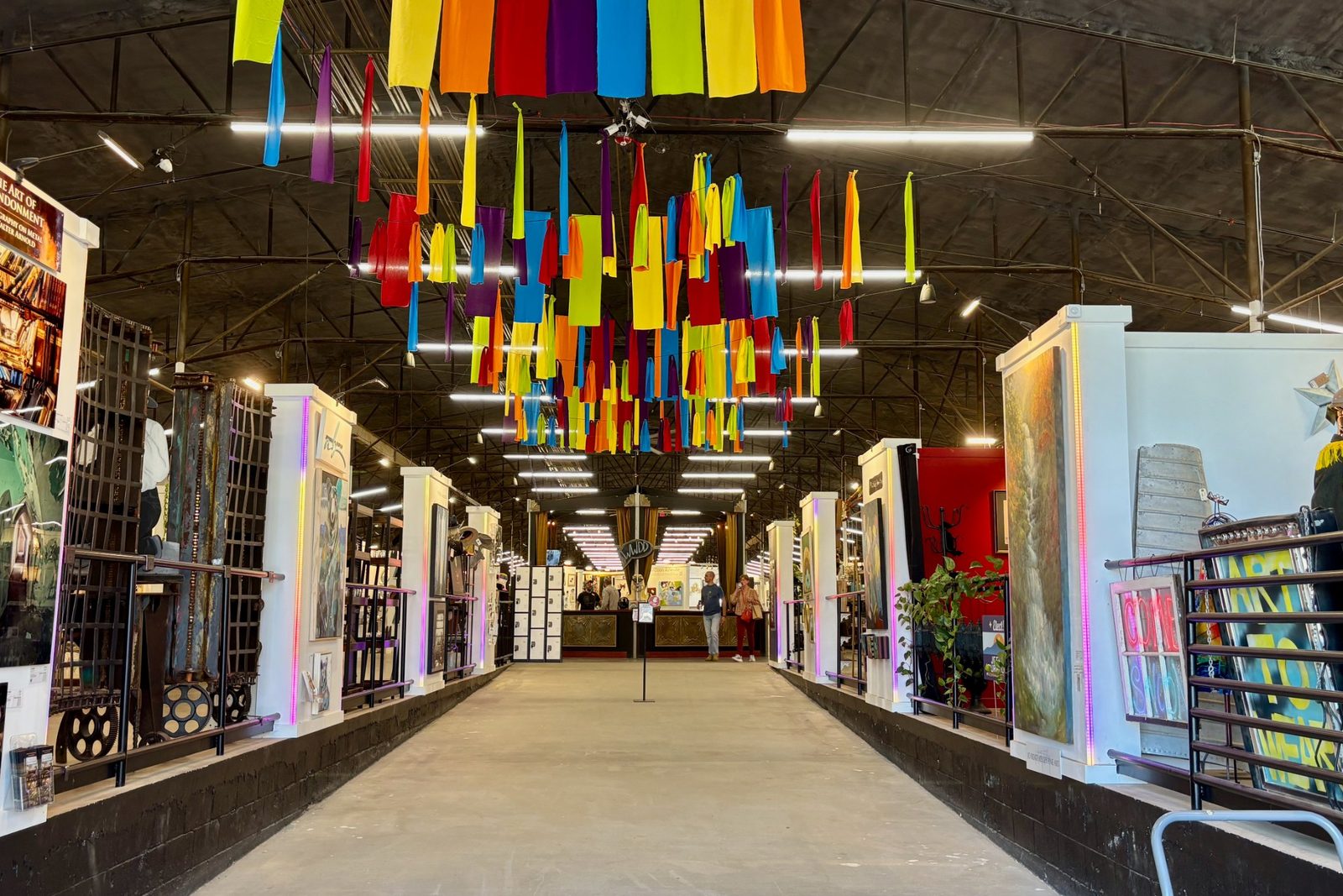 marquee-asheville-indoor-market Colorful fabric streamers over the aisles of vendor booths inside Marquee Asheville